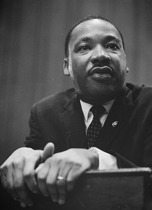Martin Luther King leaning on a lectern.