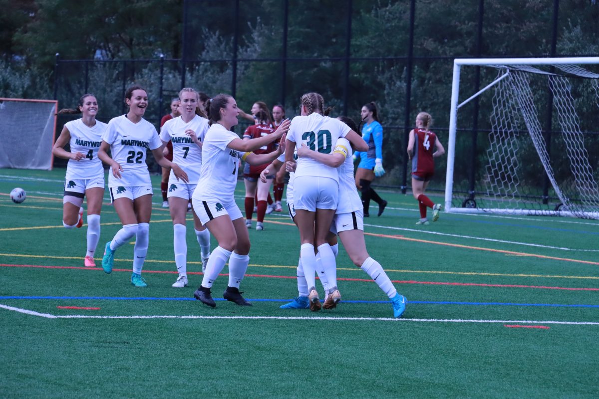 The Pacers embrace as senior Riley Mulherin scored the opening goal of the season.