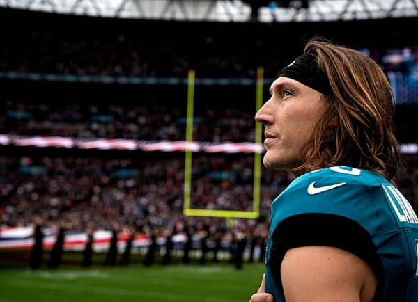 Trevor Lawrence, Jacksonville Jaguars quarterback, holds his hand over his heart during the U.S. national anthem during an NFL London game opening ceremony in England, Oct. 20, 2024. The U.K. hosts NFL games in London every year to bring together British and American communities. (U.S. Air Force photo by Airman 1st Class Cody J. A. Mott)